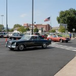 A parade of well-maintained Studebakers traverses Penn College's main campus, turning into the ATC parking lot for a lunch date with enthusiasts.