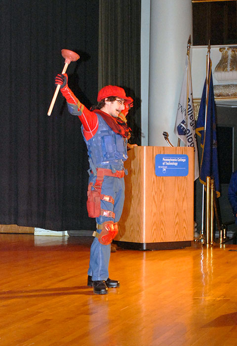 Mario, portrayed by 2013 plastics and polymer engineering technology graduate Joshua Rice, acknowledges the crowd's reception ...