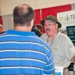 Rex E. Moore, ShaleNET U.S. consultant and instructor, talks with a visitor.