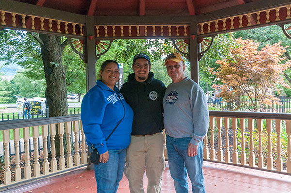 Eric M. Santiago, an automotive restoration technology student from Vineland, New Jersey, with his family in the Victorian House gazebo