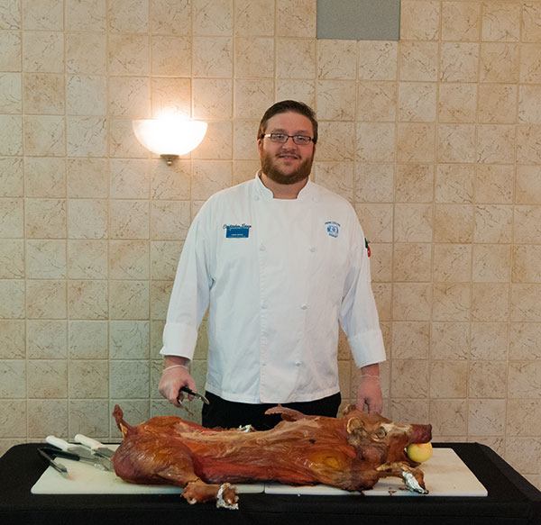 Dining Services assistant manager Christopher R. Grove, of Linden, and friend – from whom the picnic pork was pulled.