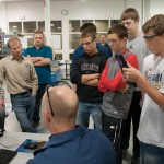 Richard K. Hendricks, seated, instructor of machine tool technology/automated manufacturing, shows Loyalsock Township High School students the 3-D modeling that comes before parts are fabricated on the computer-numerical control machines in the Advanced Manufacturing lab.