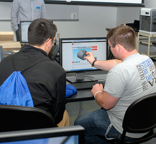 Jonathan F. DeRoner, a computer aided product design major from Thurmont, Maryland, gives a potential student a close-up look at his course work in College Avenue Labs.