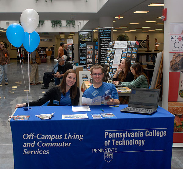 Community Assistant Sarah Boyer and Commuter Assistant Todd D. Robatin are the oh-so-pleasant gatekeepers for the Off-Campus Housing Expo in Madigan Library,