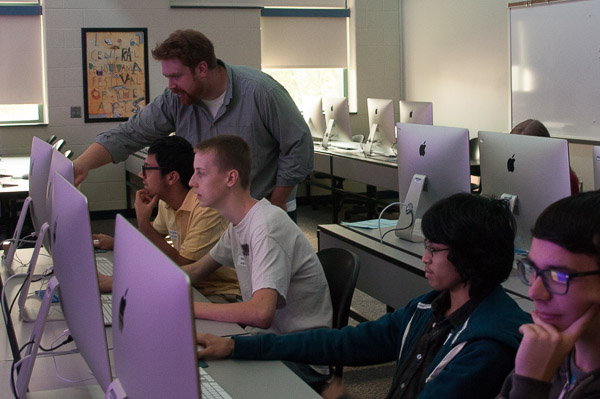 Nicholas L. Stephenson, instructor of graphic design, offers assistance in a “Graphic Design for the Web” session.