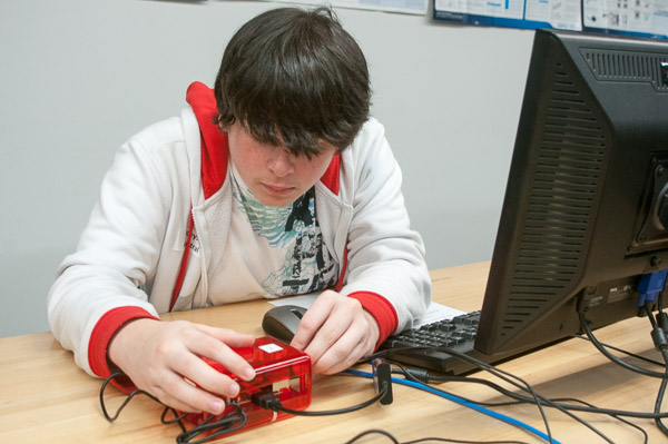 A Central Mountain High School student plugs components into a Raspberry Pi, a computer that can fit into the palm of your hand but is powerful enough to run a home media center and more.