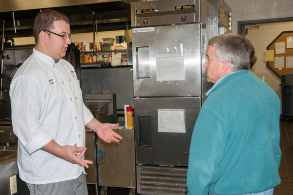 Culinary arts technology student James E. Culp, of Northumberland, shows a couple around the hospitality facilities during the Centennial Community Event.