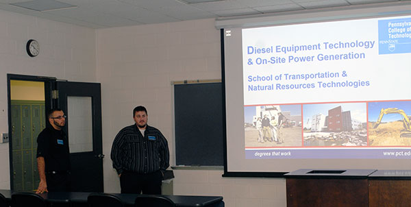 Among the diesel technology graduates returning to share their success stories were John D. Motto (left) and Daniel H. Mohlenhoff, 2011 alumni who joined instructor Justin W. Beishline's presentation. Grads from all of the college's academic schools volunteered their services for the day.