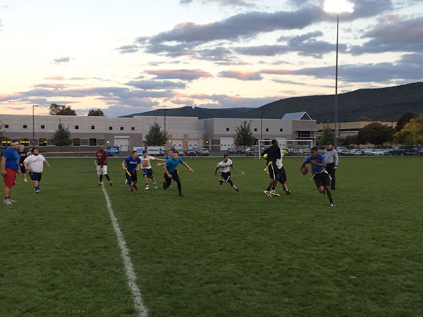 Running for daylight in the twilight of a Homecoming flag football game