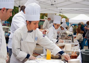 Pennsylvania College of Technology culinary arts technology student Cassandra R. Brochu serves visitors at the Williamsport Growers Market in 2011.