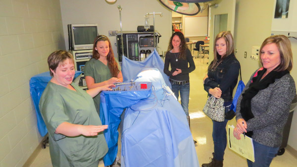 Students show visitors the ropes of the Surgical Technology Program’s simulated operating room. 