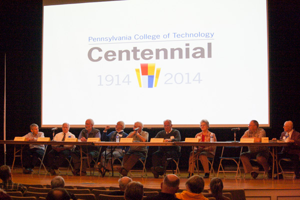 The college's Centennial logo offers an appropriate backdrop for a Q&A with WACC-era employees. From left are Edward J. McCabe, a faculty member in electrical technology occupations; Roy P. Fontaine, professor of psychology; Phillip D. Landers, emeritus professor, business administration/management; Dennis F. Ringling, retired professor of forestry; Chalmer Van Horn, retired associate professor of drafting; Dale A. Metzker, retired associate professor of printing and publishing; Bernadette Eck Servey, retired secretary to the vice president for academic affairs/provost; Charles H. Whitford, retired programmer/analyst; and Robert Kissell, who taught history and government.