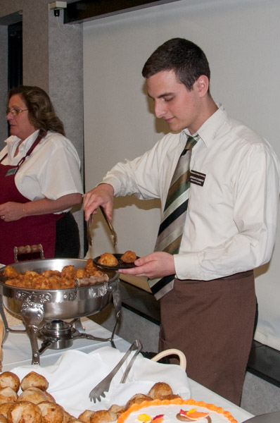 S. Jordan Stammer serves sauerkraut and sausage fritters. Stammer, who petitioned to graduate in December with dual degrees in culinary arts technology and hospitality management, has already been hired to begin work at D.B. Bistro Moderne in Manhattan in January.
