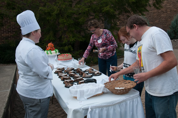 Culinary arts technology student Maria K. Maneval serves German chocolate cake to a visiting family.