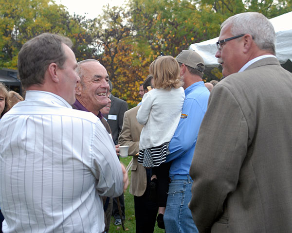 State Rep. Garth Everett (center), who serves on the college's board of directors, talks with Charles 