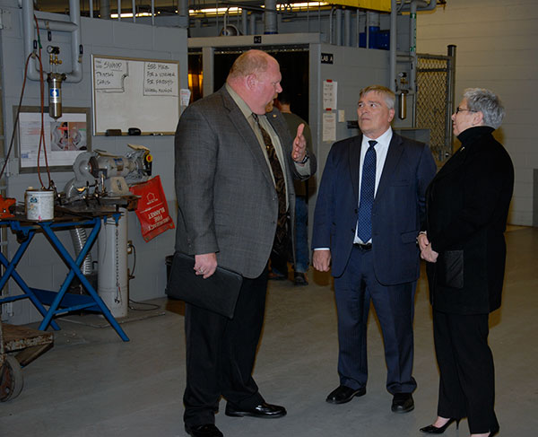 David R. Cotner, dean of industrial, computing and engineering technologies, chats with the presidents in the Avco-Lycoming Metal Trades Center.