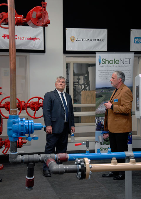 John F. Strittmatter, director of ShaleNET’s Eastern Region Hub, shows off the natural gas wellhead 