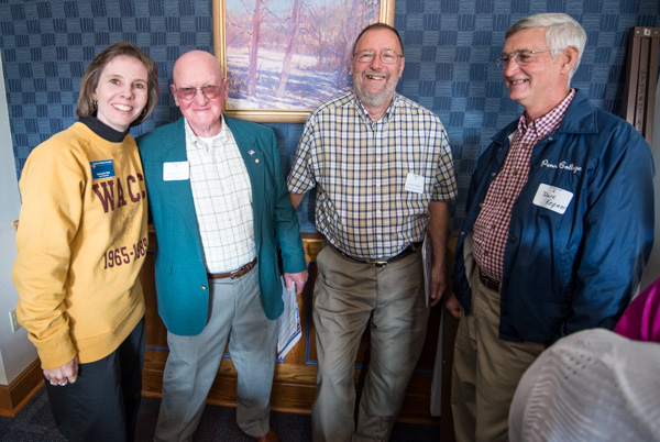 An appropriately garbed Tammy L. Rich, alumni relations director, mingles with (from left) retirees Paul Schriner, Charles Whitford and David Kepner.