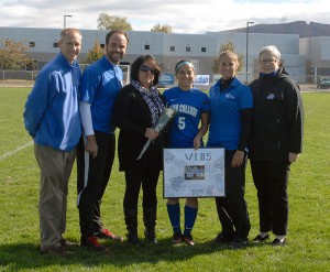 Valeria Passalacqua (5) is joined on-field by (from left) Scott Kennell, director of athletics; coach John McNichol; her mother; assistant coach Kristen Gedon; and college President Davie Jane Gilmour.
