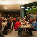 Members of the college community mingle over a family-style meal.