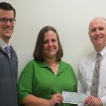 Linda Patrick, daughter of William E. Henry, alongside Mark A. Trueman (left), director of the Penn College paramedic technology program, presents a check to Barry R. Stiger, vice president for institutional advancement.