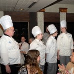 Rob A. Armstrong, sous chef in the School of Business & Hospitality, introduces the throng of patrons to the culinary arts and systems students who deliciously filled their plates: from left, Kendra J. Riggle, of Montoursville; Colleen S. Masteller, of Williamsport; and Alissa R. Martz, of Danville.
