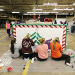 Huddled for the holidays, members of the Student American Dental Hygienists' Association work on their entry.