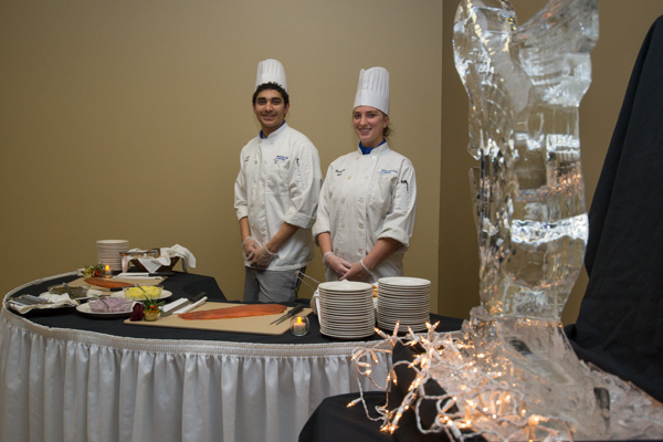 Serving smoked salmon in a KDR corner are Jacob O. Spencer, of Millersville, majoring in culinary arts technology, and Elizabeth M. Ball, of Phoenixville, a culinary arts and systems student.