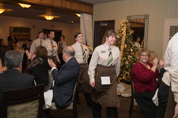 Patrons' applause greets the students' traditional after-dinner walk through the dining room.