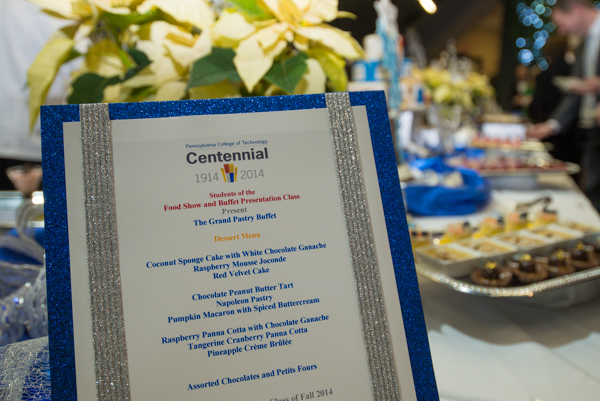 The Centennial logo tops the menu for The Grand Pastry Buffet, spotlighted at evening's end in the atrium area of KDR.