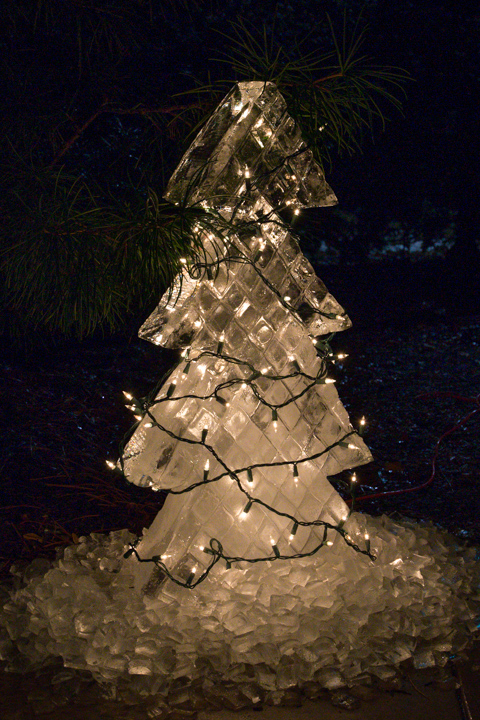 An exterior ice sculpture of a Christmas tree, complete with shimmering lights, welcomes guests to Le Jeune Chef.