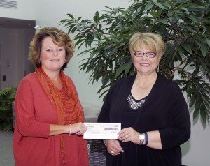 Frontier Communications’ Jennifer Sherwood, left, presents a check to Debra M. Miller, Penn College’s director of corporate relations.