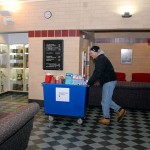 Steve Wenzel, from the Salvation Army in Williamsport, wheels a binload of donations through the Bush Campus Center.