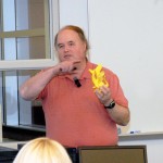 Eric K. Albert enhances his presentation with pass-around examples of additive manufacturing.