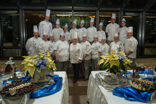 The baking and pastry arts team gathers with soon-to-retire faculty member Sue L. Mayer, assistant professor of baking and pastry arts/culinary arts, front-and-center. Among those joining their colleague are Todd M. Keeley and Chef Charles R. Niedermyer II (on left in first and second rows, respectively) and Chef Monica J. Lanczak (front row, second from right) – all instructors of baking and pastry arts/culinary arts.
