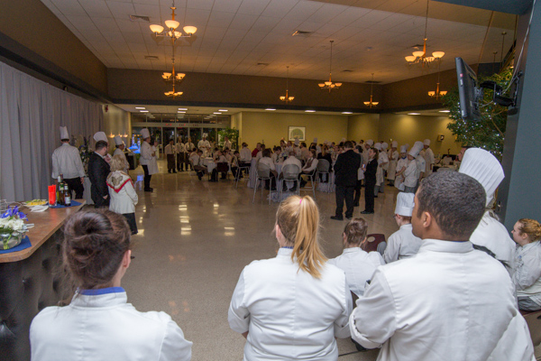 In a pair of preparatory pep talks, Chef Paul E. Mach, assistant professor<br />
hospitality management/culinary arts, briefs students gathered in KDR ...