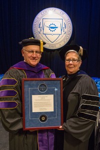 State Sen. Gene Yaw, chairman of the Pennsylvania College of Technology Board of Directors, is presented with the Centennial Leadership Award by Penn College President Davie Jane Gilmour at the college's Winter Commencement ceremonies.