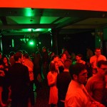 The dance floor is bathed in seasonally appropriate red and green.