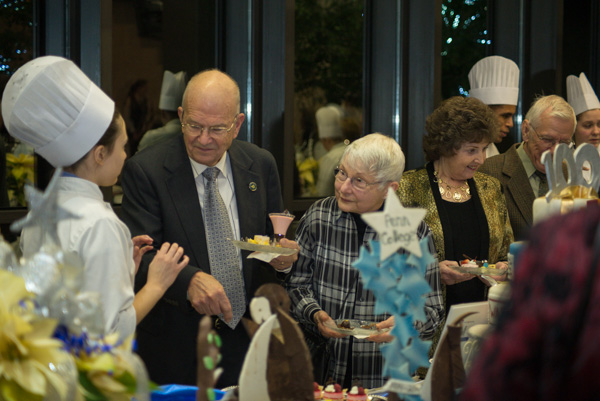 Carl and Lois Wolgemuth receive assistance from student Diana N. Lindner in navigating an array of delights. Lindner is a baking and pastry arts major from North White Plains, New York.