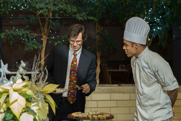 Daniel C. Frankenfield, a baking and pastry arts student from Dushore and a Wildcat wrestler, helps Richard F. Schluter choose a few winning selections from the buffet. Schluter is a partner in McCormick Law Firm, a supporter of legal assistant/paralegal scholarships.