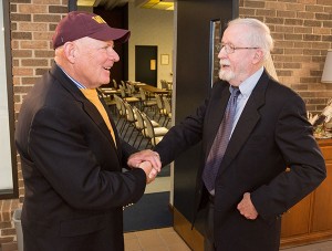 Darryl Kehrer, left, greets Daniel J. Doyle on the Penn College campus. Kehrer and his wife, Dawn, both alumni of the college’s immediate predecessor, Williamsport Area Community College, established a scholarship in honor of Doyle, a professor emeritus of history.