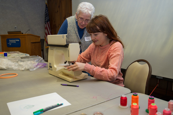 Amanda McCavour (seated) provides artistic assistance to workshop participant Sally Ickes, of Danville. 