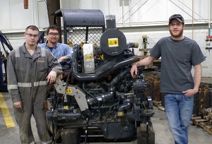 Penn College students Olen J. Brown (left) of Canton and Drew M. Chronister (right), of Tyrone, gather with diesel equipment technology instructor Chris S. Weaver alongside an engine donated by Anderson Equipment Co. (Photo by Pamela A. Mix, secretary to the Schneebeli Earth Science Center executive director and assistant dean of transportation and natural resources technologies)