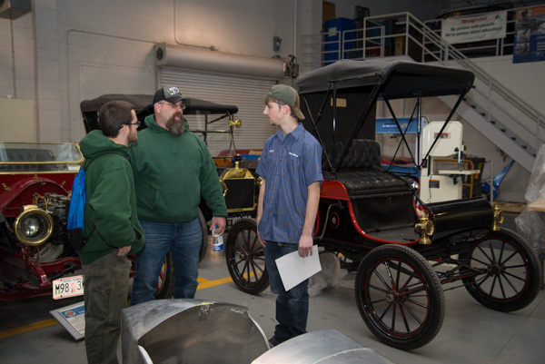 Ryan J. Bollinger, a freshman in automotive restoration technology from Mount Joy, shows off his lab's vintage vehicles to visitors. 