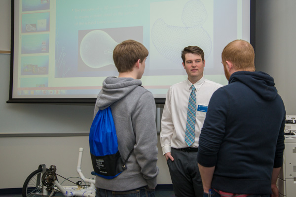 Alumnus Christopher J. Allebach ('13, computer aided product design, and '12, computer aided drafting technology) chats with visitors in an engineering design technology lab where he presented 