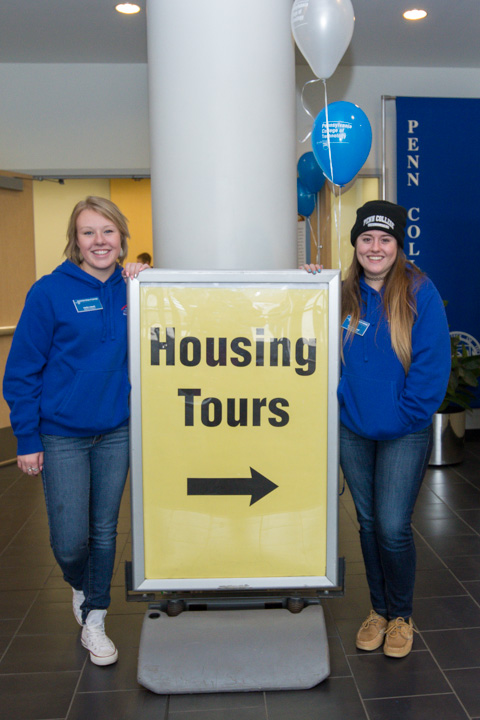 Standing ready in the Dauphin Hall lobby, Resident Assistants Hallie J. Liberti (left) and Charlie A. Geisel offer a warm welcome on a chilly day.