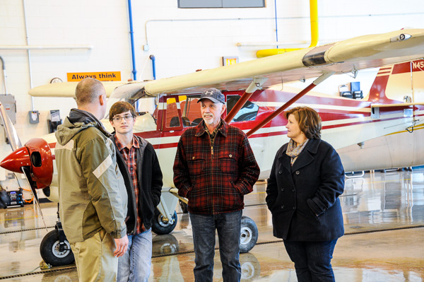 Aviation instructor Michael R. Robison takes an Open House group through the airport hangar.