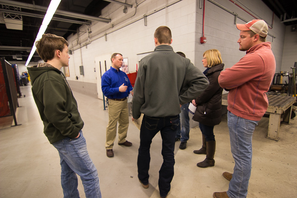 Welding lecturer James C. Tanner meets with a group in the Avco Lycoming Metal Trades Center.
