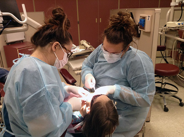 Placing sealants are Morgan A. Atherton (left), of Newburg, and Barbie A. Hanson, of Phoenixville ...