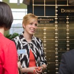 The Donor Wall offers a reflective backdrop for Elizabeth A. Biddle, director of corporate relations, and friends.